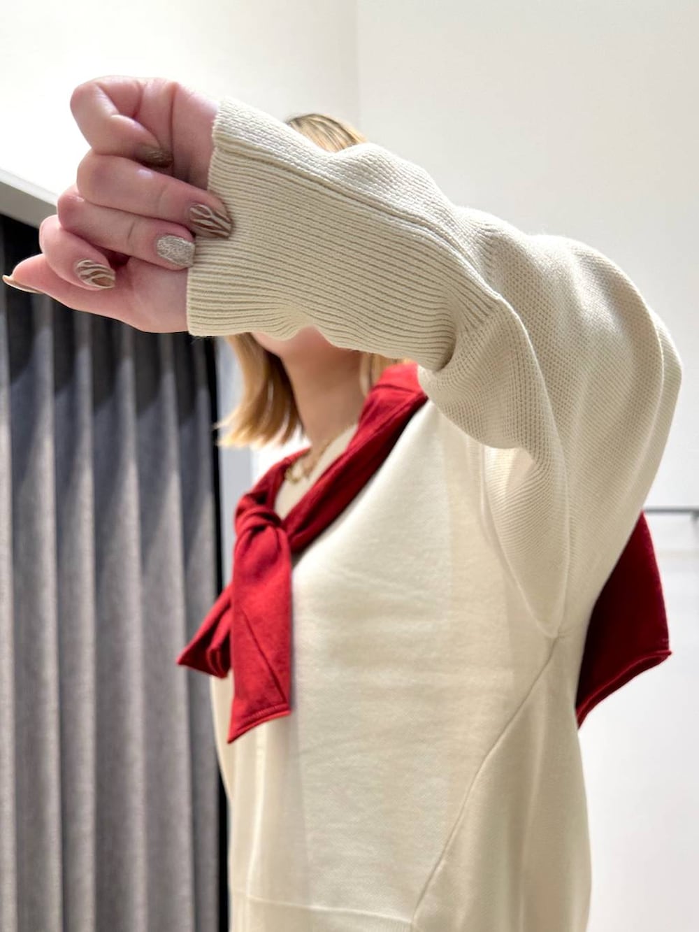 ブラウン系のスカート、ホワイト系のニット/セーター、ブラック系のトートバッグを着用したレディースの秋コーディネートの7枚目の写真