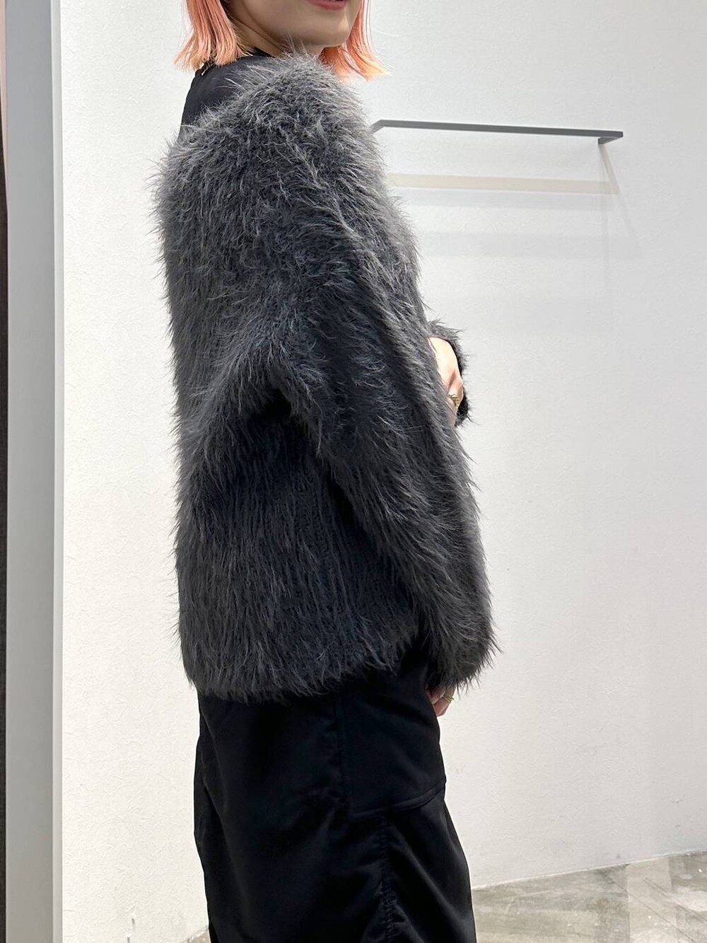 ブラック系のスカート、ブラック系のブーツ、ブラック系のTシャツ/カットソーを着用したレディースの秋コーディネートの6枚目の写真