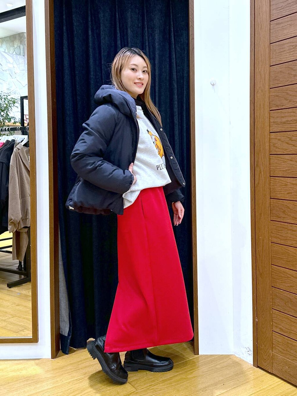 ブルー系のダウンジャケット/コート、ブラック系のブーツ、ブラック系のTシャツ/カットソーを着用したレディースの冬コーディネートの2枚目の写真