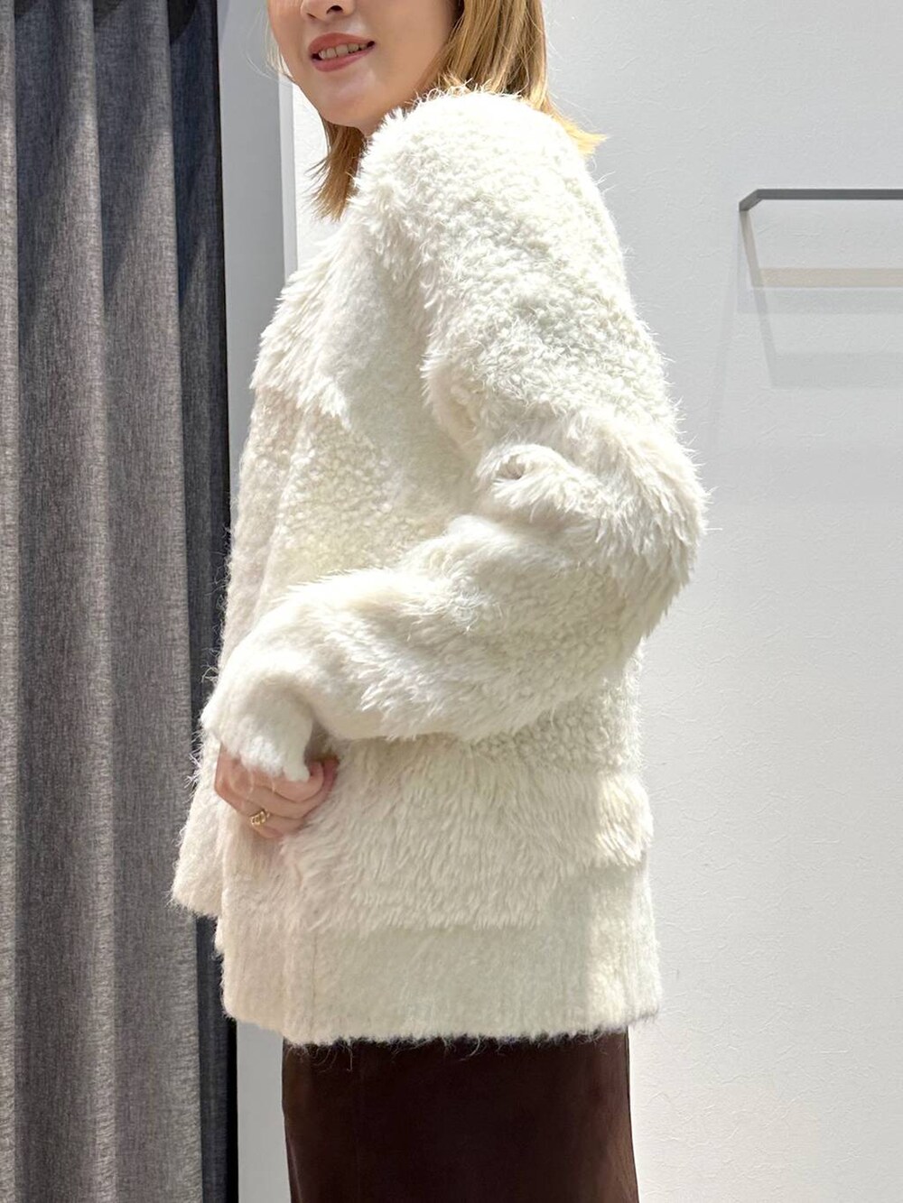 ホワイト系のTシャツ/カットソー、ブラウン系のスカート、ブラック系のトートバッグを着用したレディースの秋コーディネートの8枚目の写真