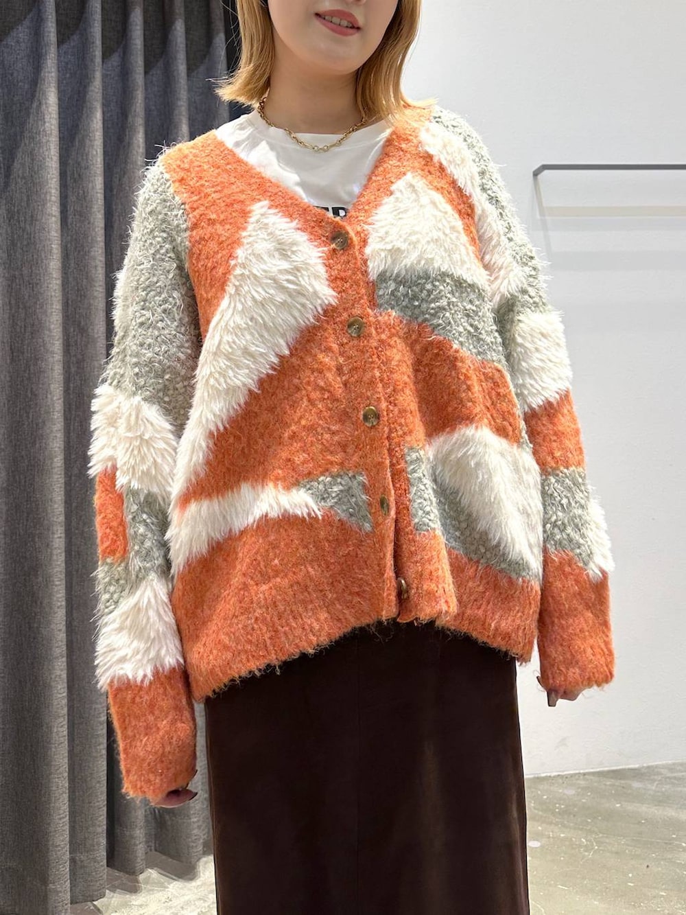 ホワイト系のTシャツ/カットソー、ブラウン系のスカート、ブラック系のトートバッグを着用したレディースの秋コーディネートの4枚目の写真