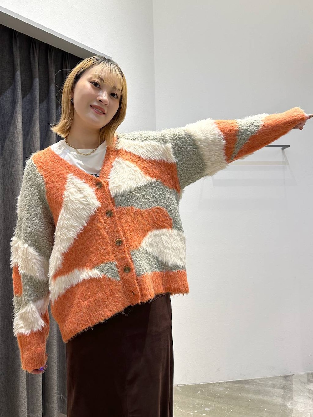 ホワイト系のTシャツ/カットソー、ブラウン系のスカート、ブラック系のトートバッグを着用したレディースの秋コーディネートの5枚目の写真