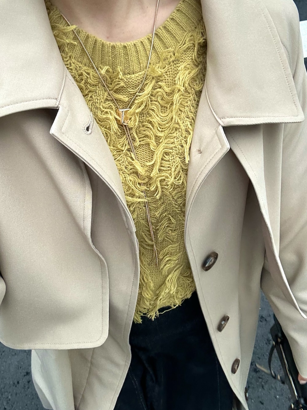 イエロー系のカーディガン/ボレロ、ベージュ系のステンカラーコートを着用したレディースの冬コーディネートの4枚目の写真