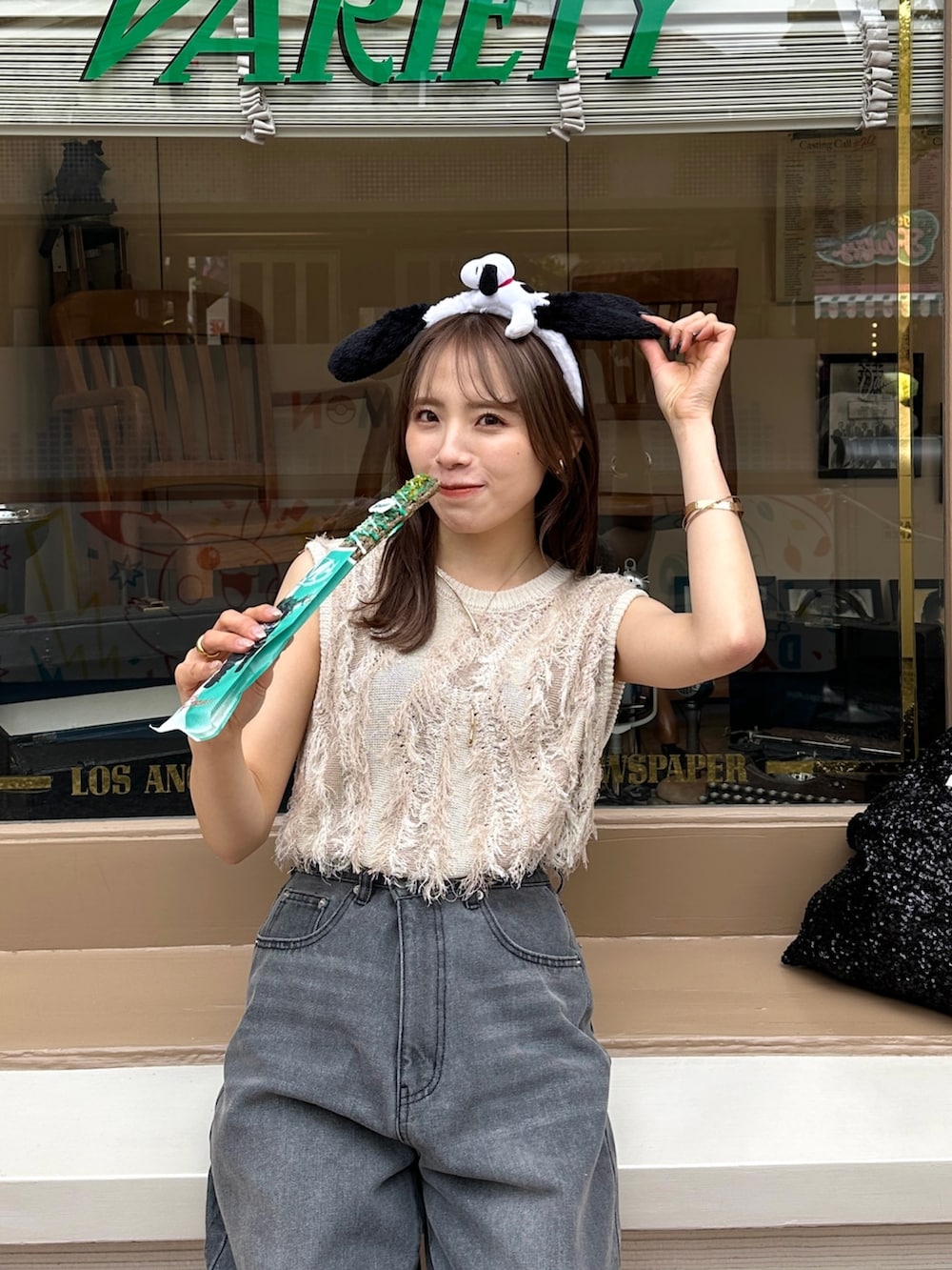 ブラック系のデニムパンツ、ホワイト系のニット/セーターを着用したレディースの春コーディネートの2枚目の写真