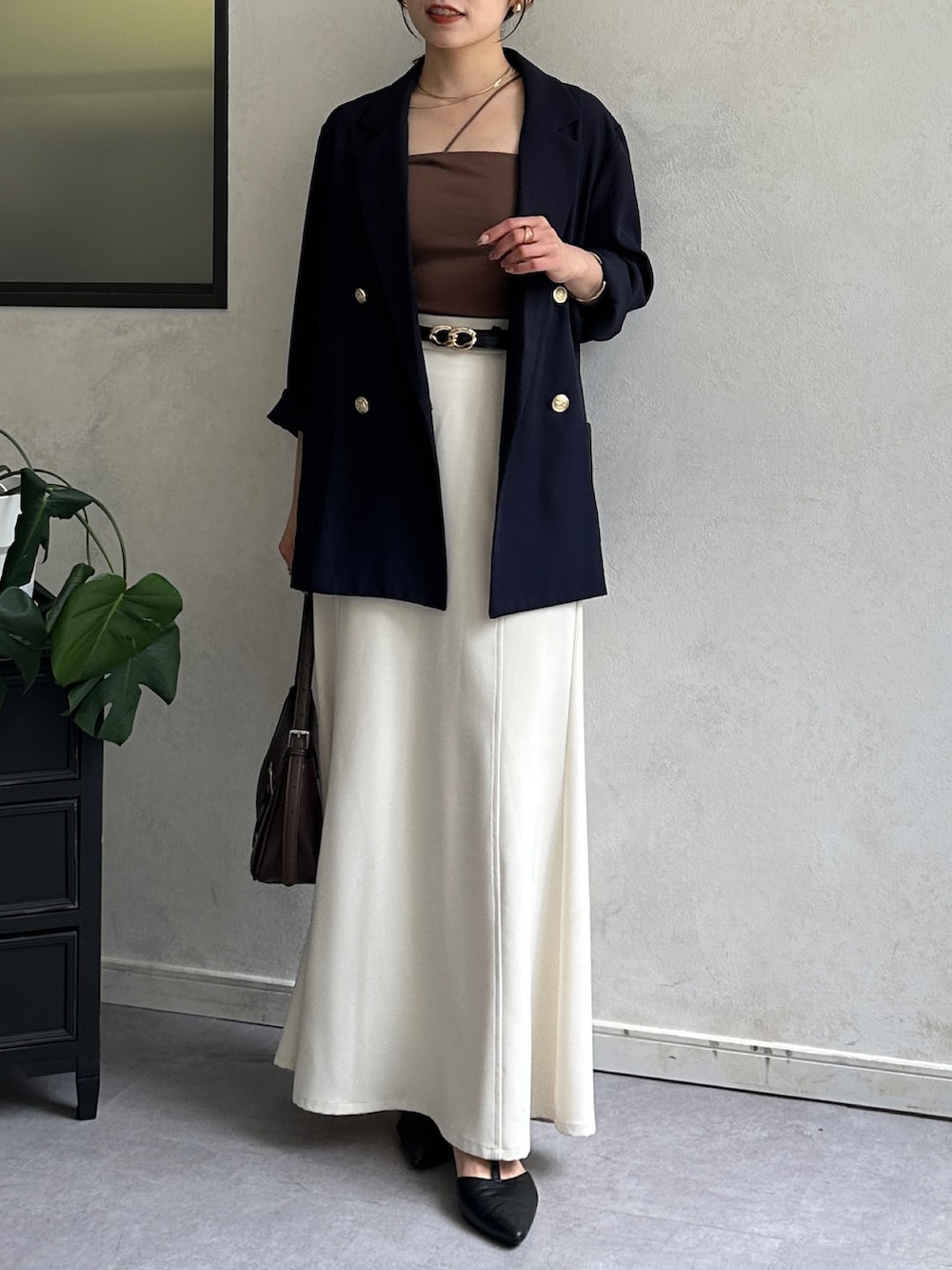 ホワイト系のスカート、ブラック系のパンプス、ブルー系のテーラードジャケットを着用したレディースの夏コーディネートの2枚目の写真