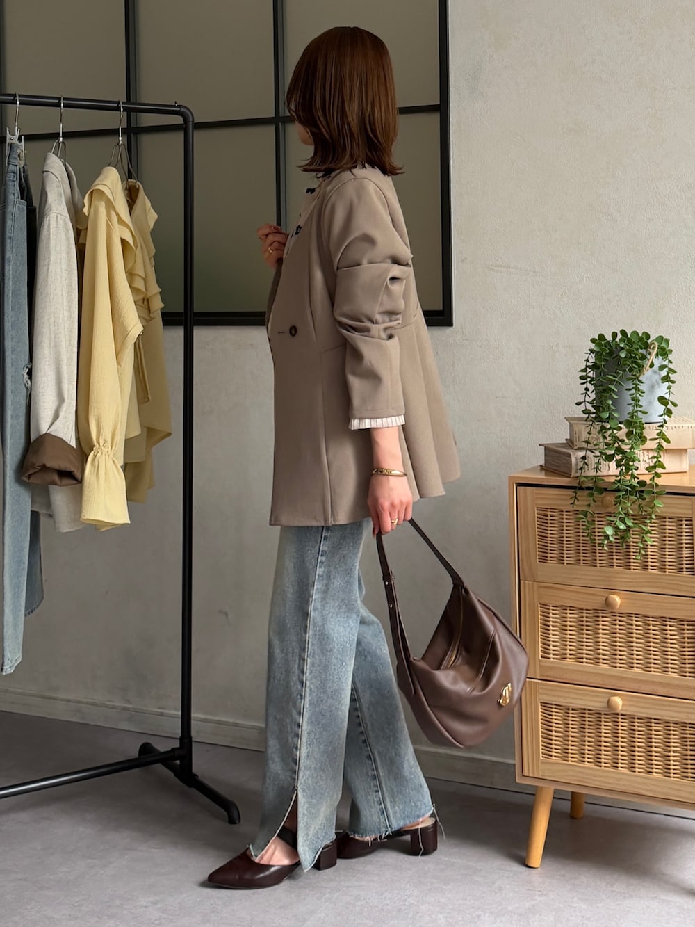 ベージュ系のテーラードジャケット、ホワイト系のシャツ/ブラウス、ブラウン系のパンプスを着用したレディースの春コーディネートの3枚目の写真