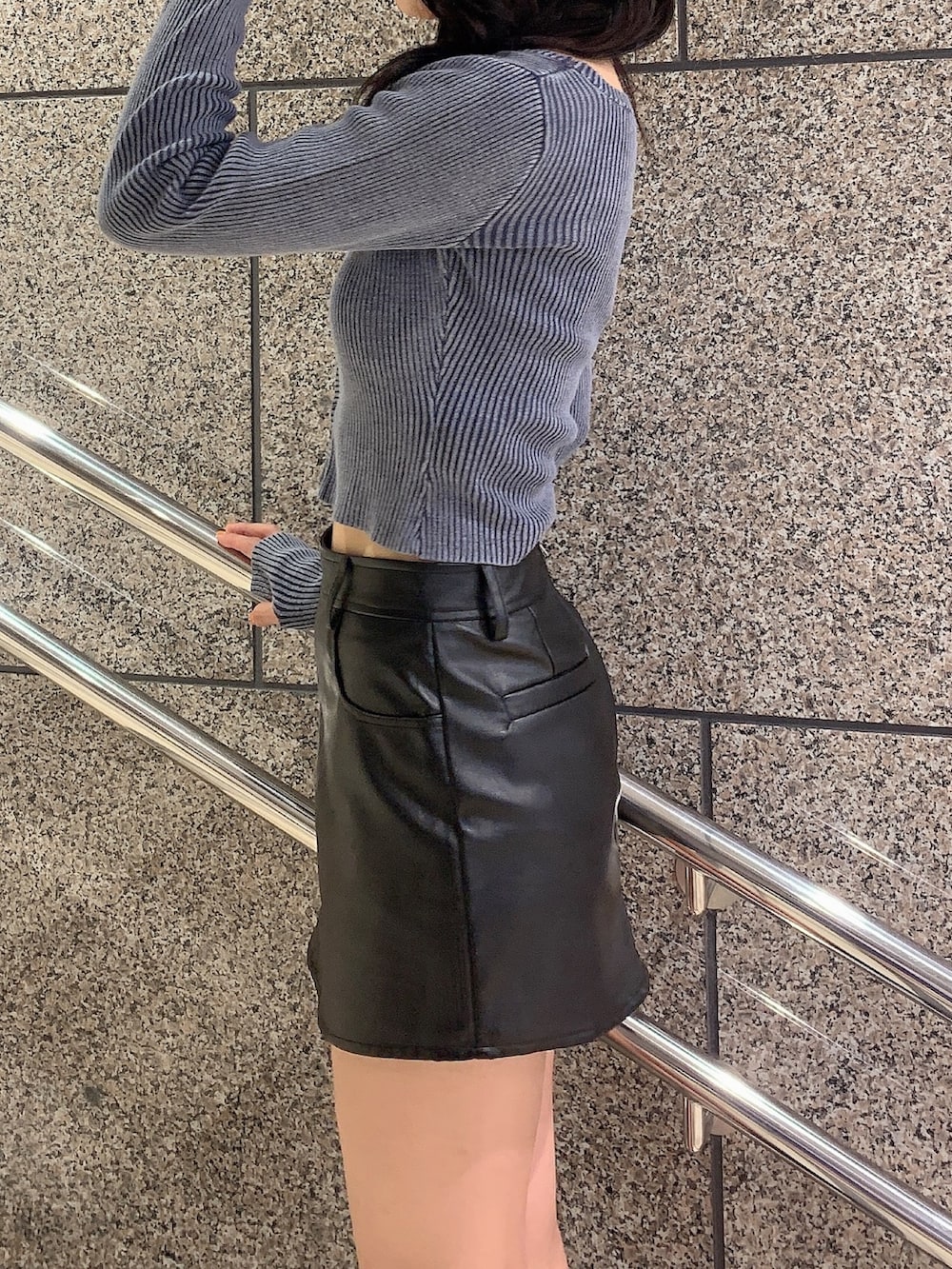 ブラック系のスカート、ブルー系のニット/セーター、ブラック系のブーツを着用したレディースの秋コーディネートの5枚目の写真