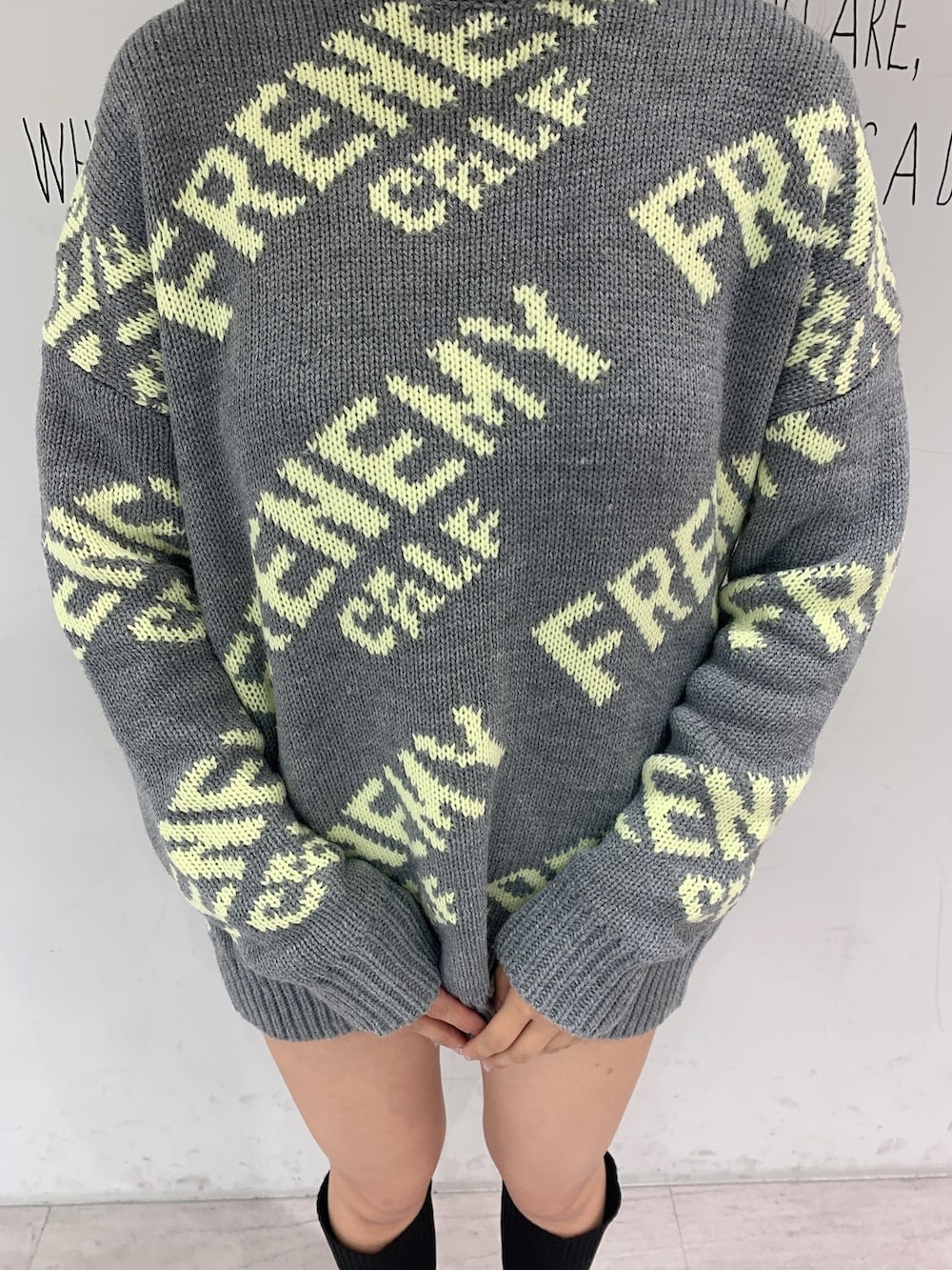 ブラック系のブーツ、ブラック系のデニムパンツ、グレー系のニット/セーターを着用したレディースの秋コーディネートの6枚目の写真