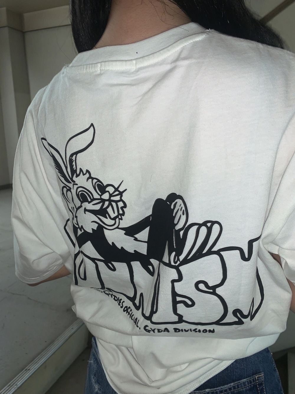 ブルー系のデニムスカート、ホワイト系のサンダル、ホワイト系のTシャツ/カットソーを着用したレディースの春コーディネートの6枚目の写真