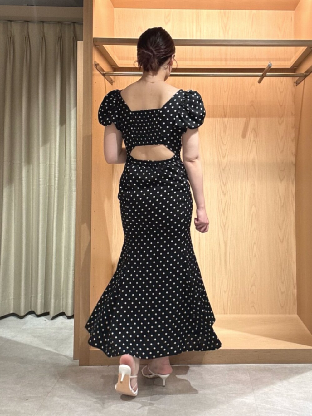 ブラック系のワンピース、ホワイト系のサンダルを着用したレディースの夏コーディネートの3枚目の写真