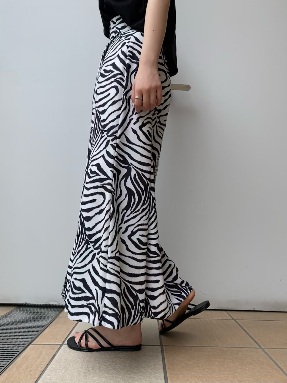 ブラック系のサンダル、その他のスカート、ブラック系のタンクトップを着用したレディースの夏コーディネートの4枚目の写真