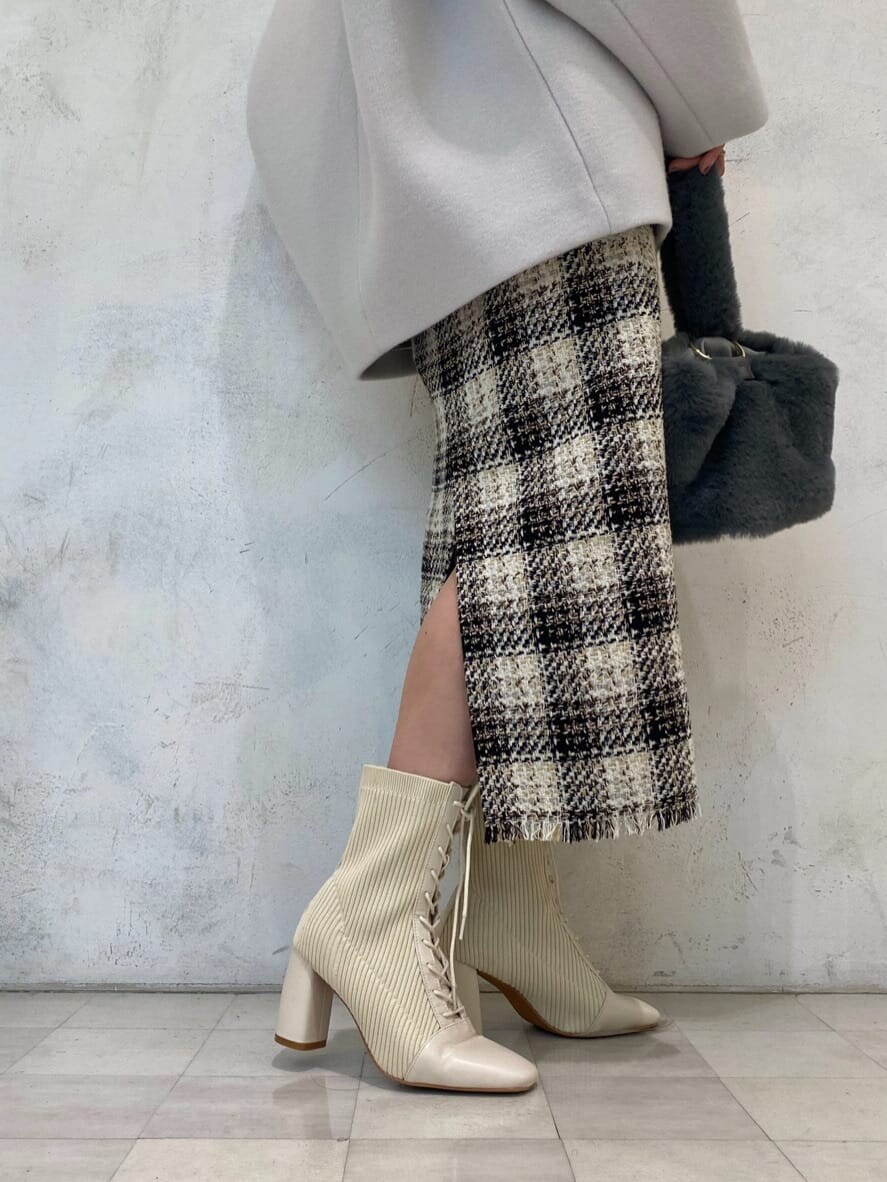 グリーン系のブルゾン、ピンク系のニット/セーター、ホワイト系のブーツを着用したレディースの秋コーディネートの5枚目の写真