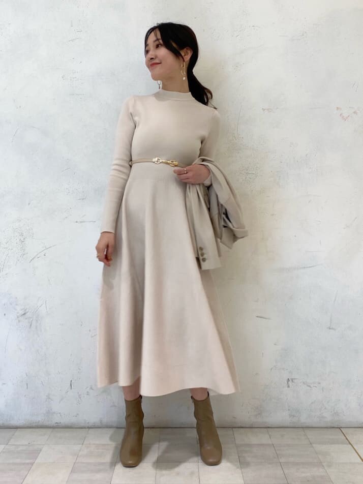 ベージュ系のブーツ、ベージュ系のテーラードジャケット、ホワイト系のワンピースを着用したレディースの秋コーディネートの6枚目の写真