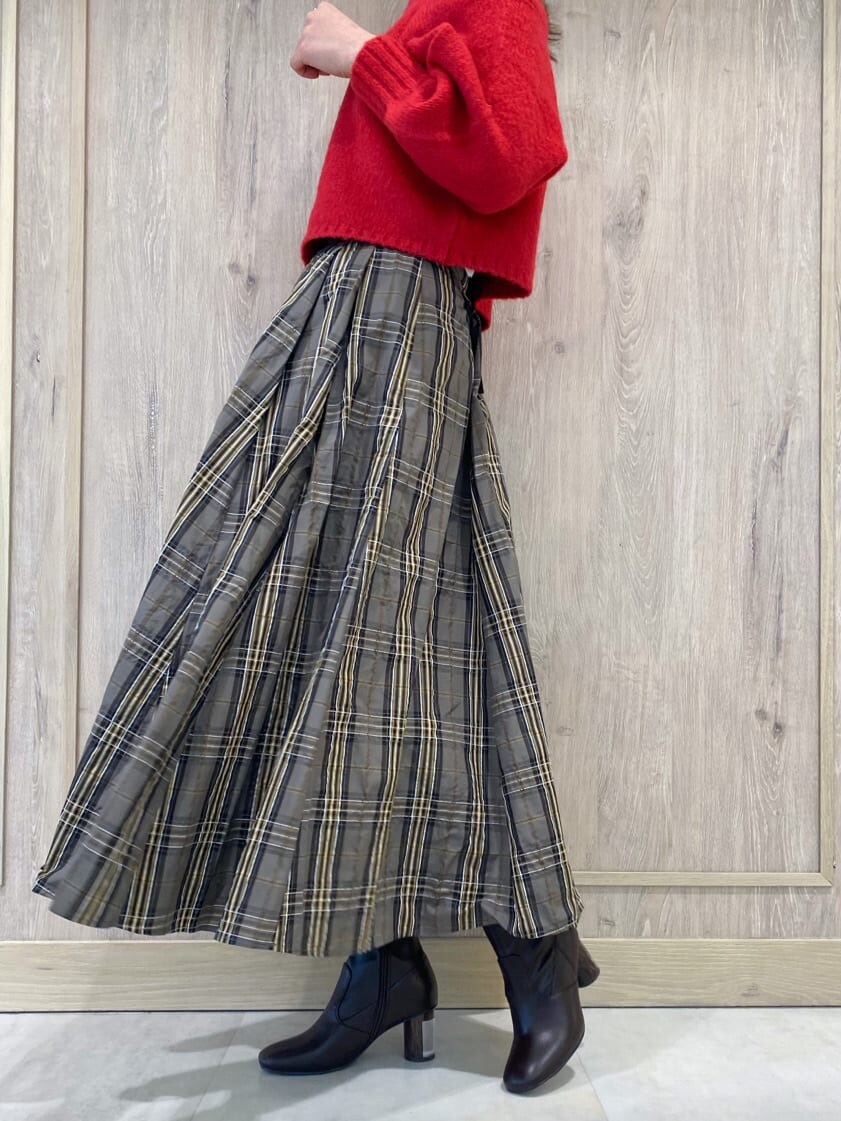 ベージュ系のスカート、ブラウン系のブーツ、ピンク系のニット/セーターを着用したレディースの秋コーディネートの9枚目の写真