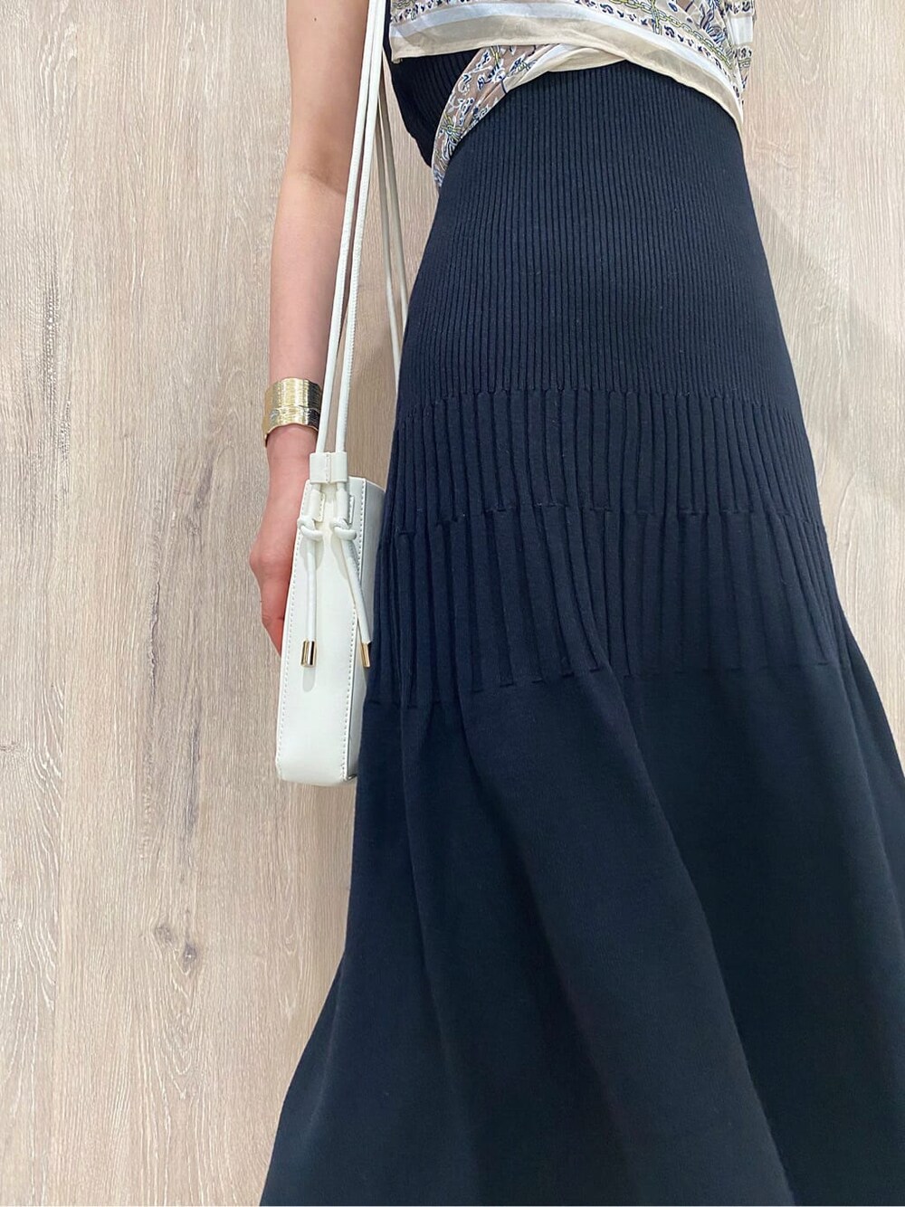 ブラック系のワンピース、イエロー系のサンダル、ホワイト系のハンドバッグを着用したレディースの夏コーディネートの5枚目の写真