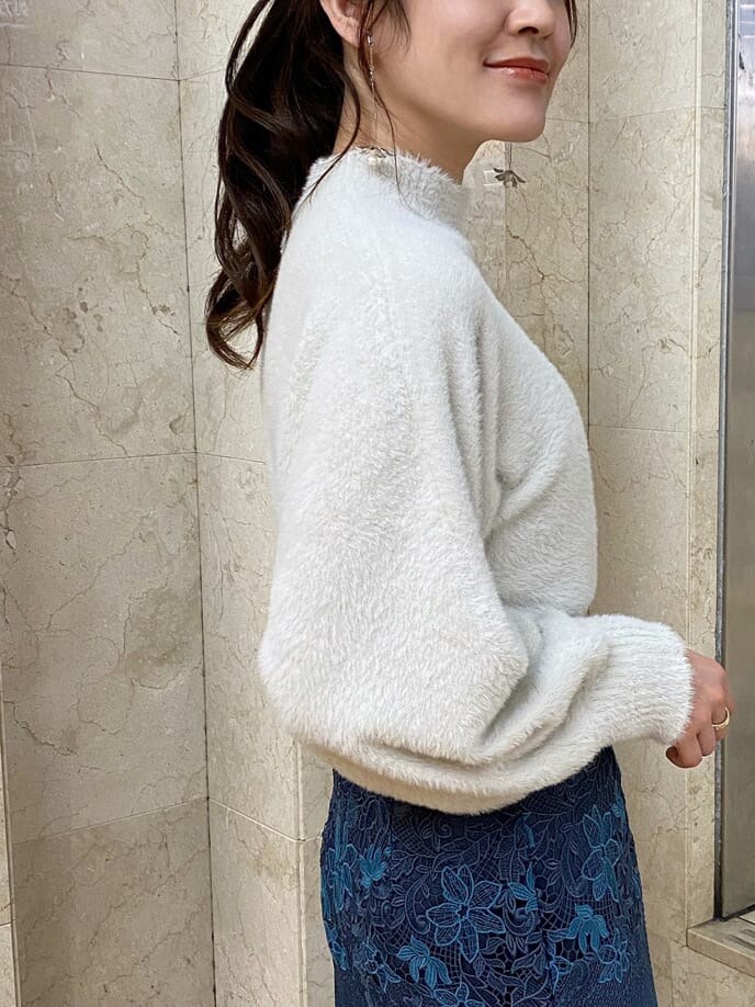 グリーン系のチェスターコート、ブルー系のスカート、ブラック系のその他シューズを着用したレディースの秋コーディネートの8枚目の写真