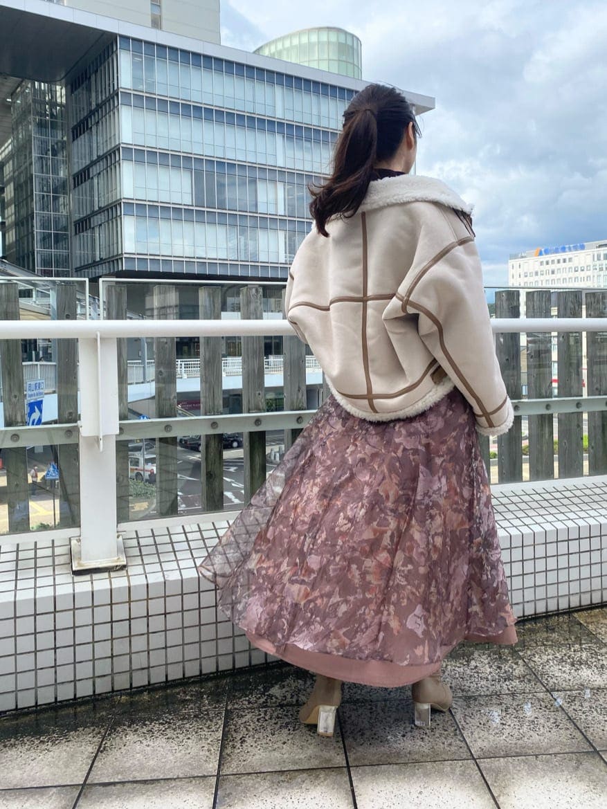 ベージュ系のブーツ、ベージュ系のムートンコート、ブラウン系のニット/セーターを着用したレディースの秋コーディネートの5枚目の写真