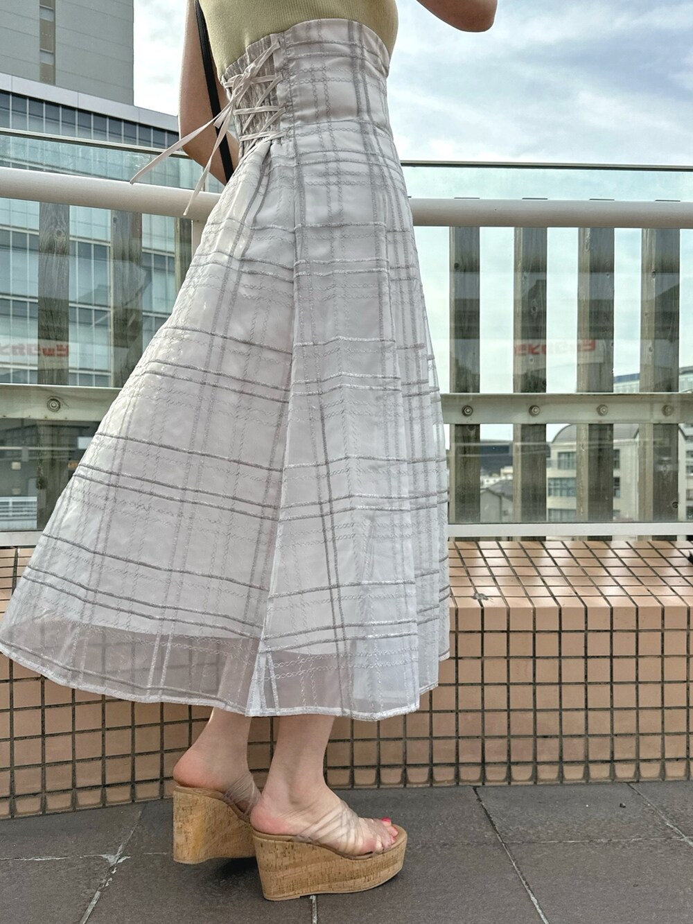 その他のサンダル、ブラック系のハンドバッグ、グリーン系のワンピースを着用したレディースの春コーディネートの9枚目の写真