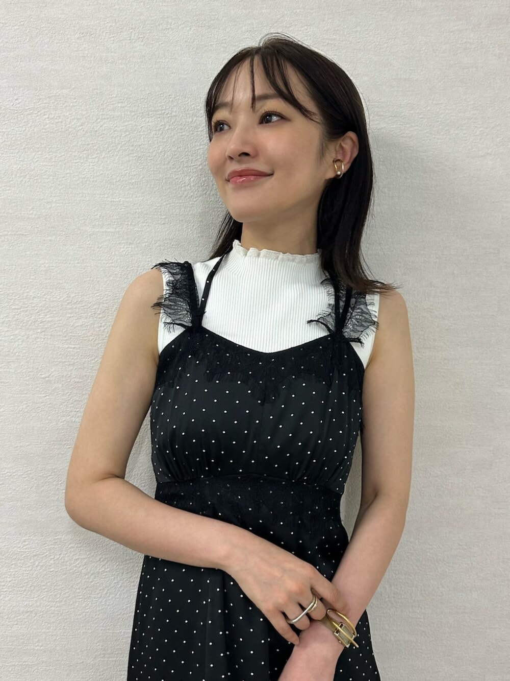 グリーン系のショルダーバッグ、ブラック系のワンピース、ブラック系のブーツを着用したレディースの夏コーディネートの5枚目の写真