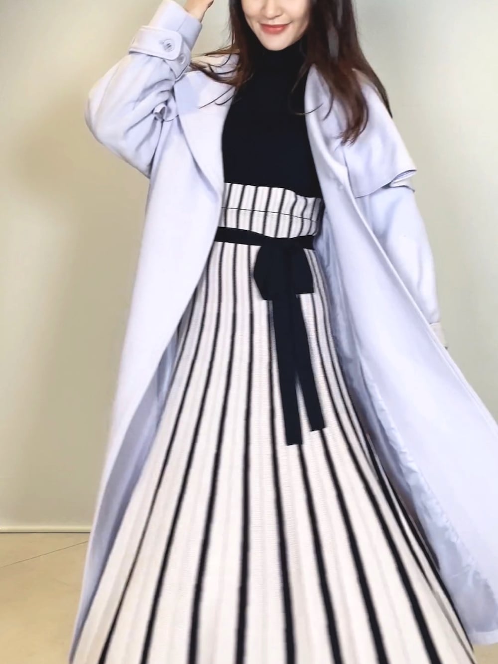 ブラック系のブーツ、ブラック系のワンピース、グレー系のその他アウターを着用したレディースの冬コーディネートの5枚目の写真