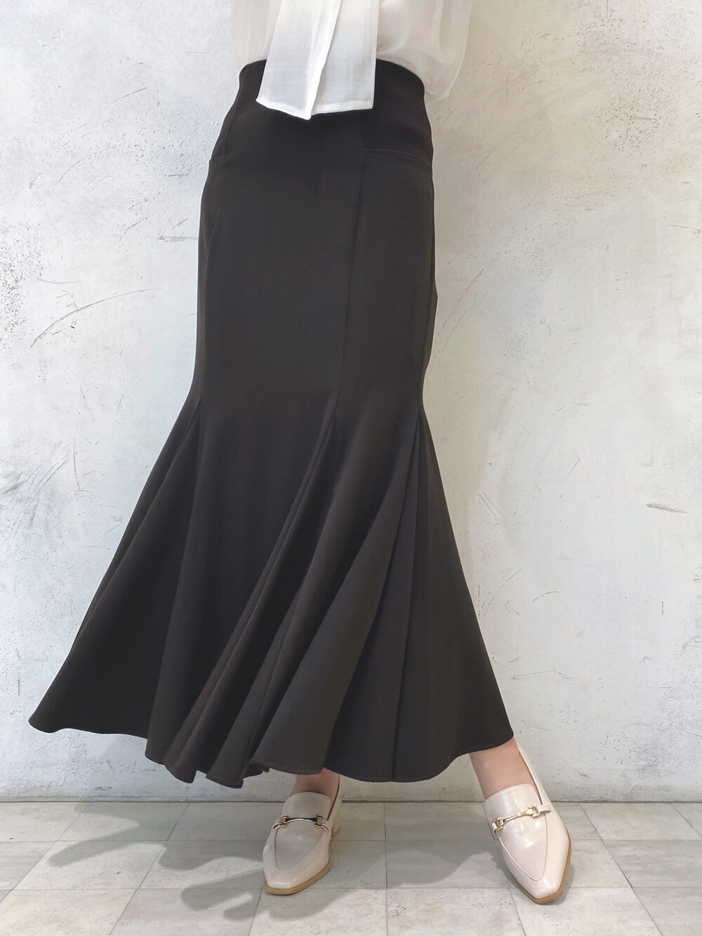 ホワイト系のローファー、パープル系のカーディガン/ボレロ、ブラウン系のスカートを着用したレディースの秋コーディネートの9枚目の写真