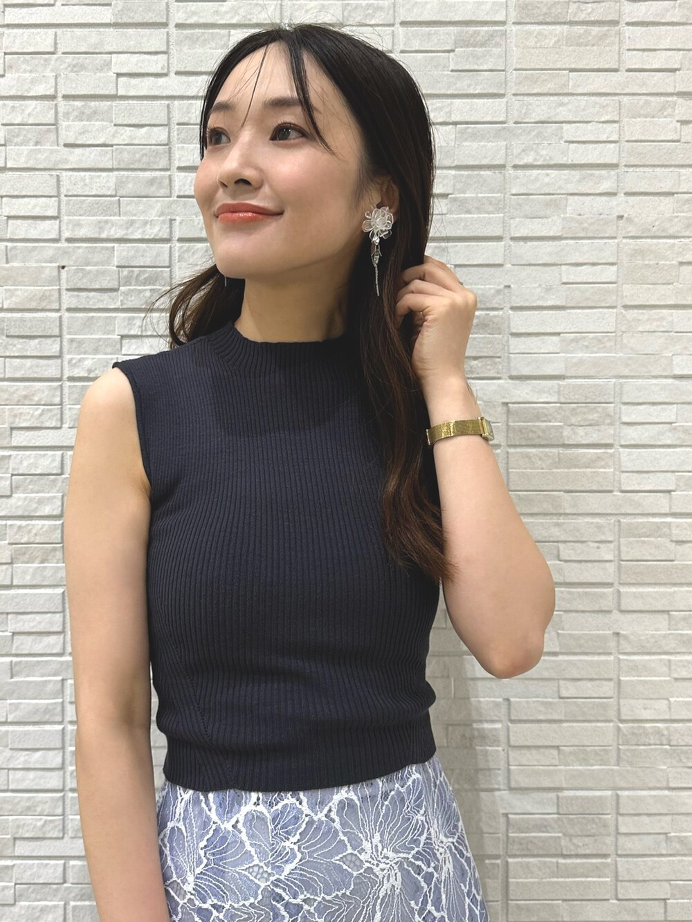 ブラック系のチューブトップ、ブルー系のスカート、ブラウン系のサンダルを着用したレディースの夏コーディネートの5枚目の写真