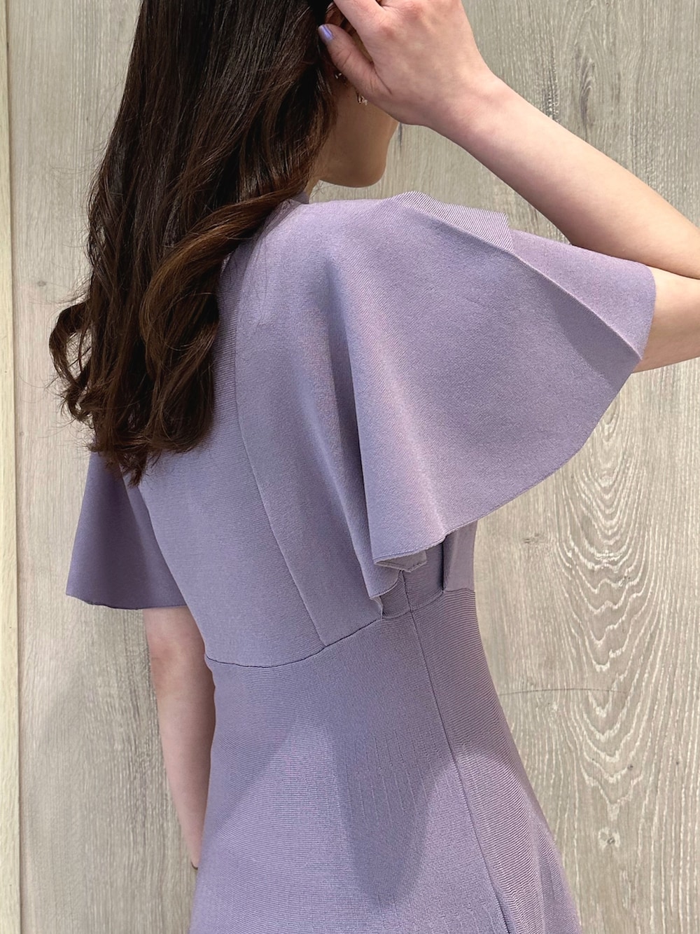 ブラウン系のハンドバッグ、ブラウン系のブーツ、パープル系のワンピースを着用したレディースの春コーディネートの6枚目の写真