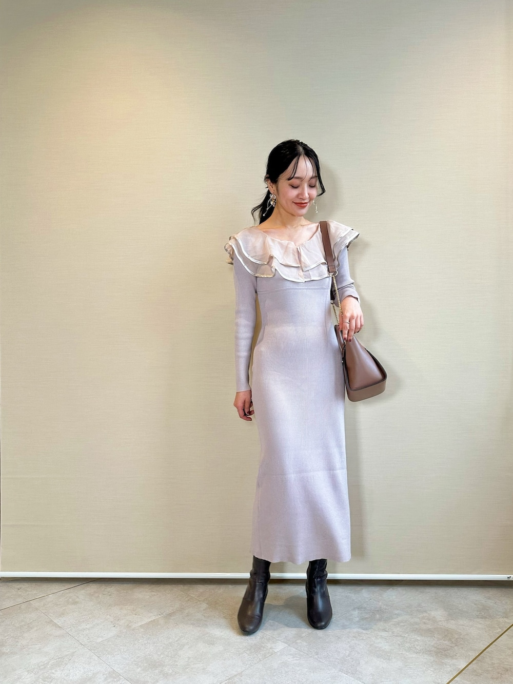 ブラウン系のブーツ、ブラウン系のハンドバッグ、ピンク系のワンピースを着用したレディースの冬コーディネートの2枚目の写真