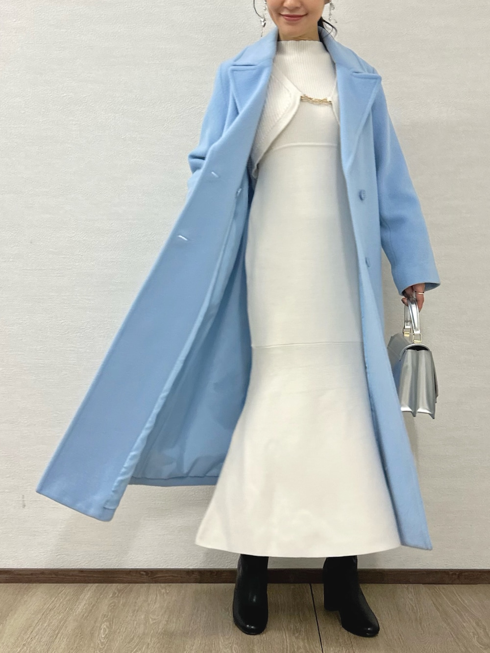 ブラック系のブーツ、シルバー系のハンドバッグ、ホワイト系のワンピースを着用したレディースの秋コーディネートの2枚目の写真