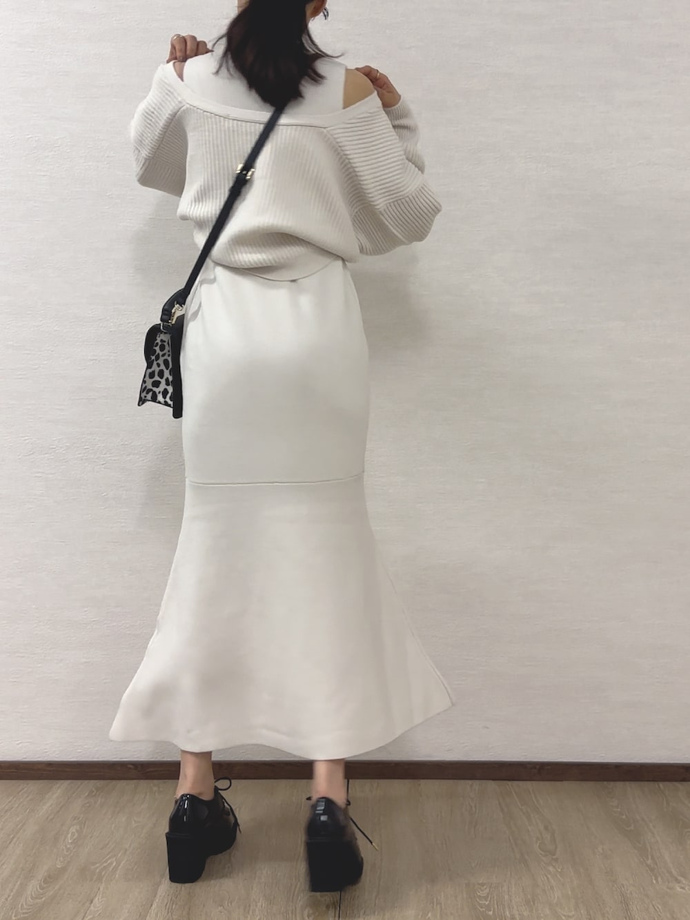 ホワイト系のワンピース、ブラック系のハンドバッグ、ブラック系のローファーを着用したレディースの秋コーディネートの4枚目の写真