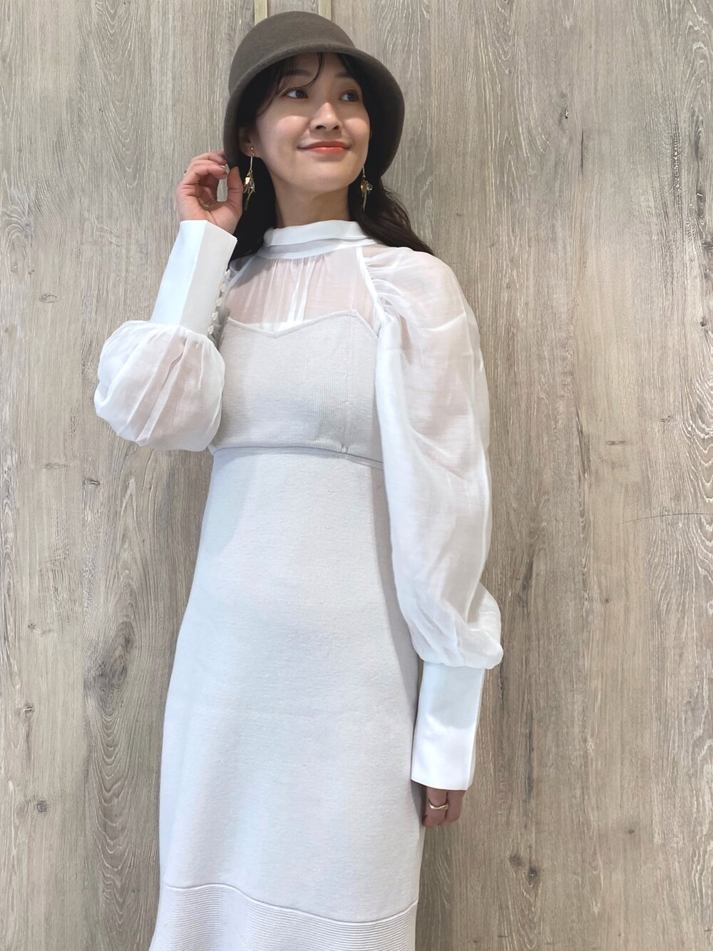 ベージュ系のブーツ、ホワイト系のワンピース、ホワイト系のチューブトップを着用したレディースの冬コーディネートの5枚目の写真