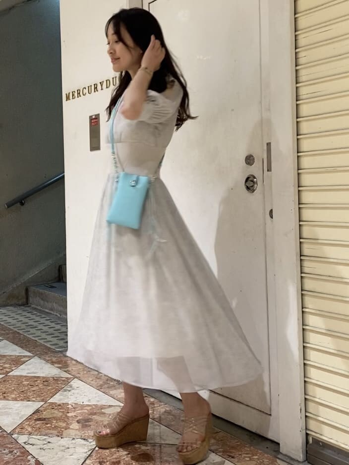 その他のサンダル、ホワイト系のワンピース、グリーン系のショルダーバッグを着用したレディースの夏コーディネートの2枚目の写真