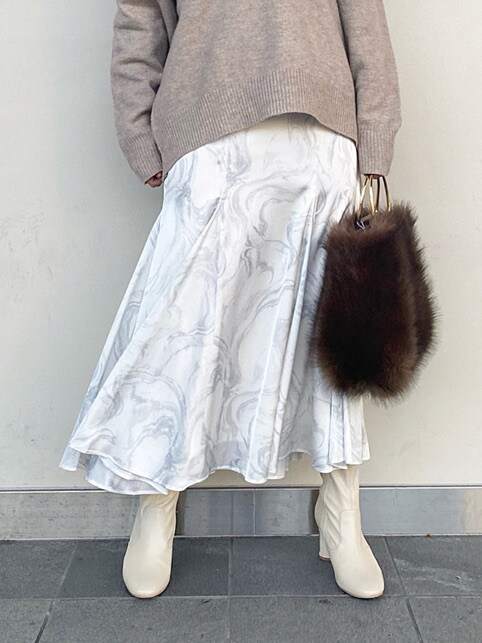 ホワイト系のブーツ、ホワイト系のスカート、ベージュ系のニット/セーターを着用したレディースの冬コーディネートの5枚目の写真