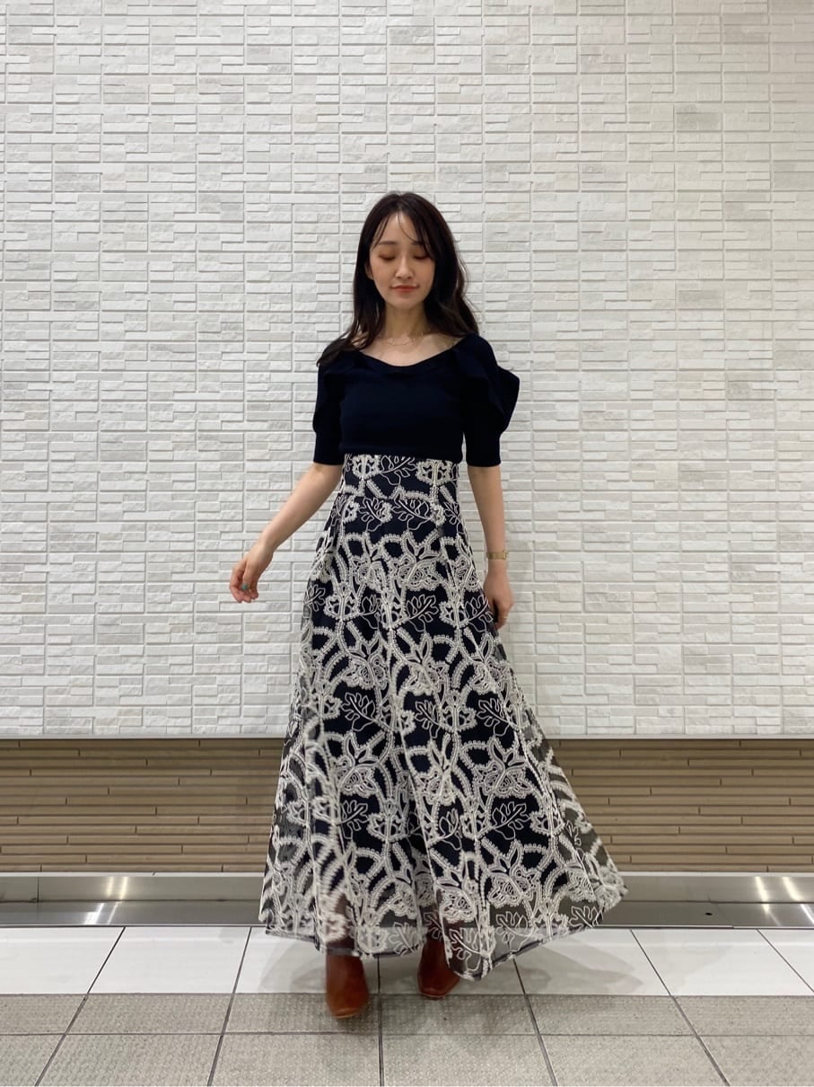 ベージュ系のキャミソール、ブラック系のニット/セーター、ブラック系のスカートを着用したレディースの夏コーディネートの2枚目の写真