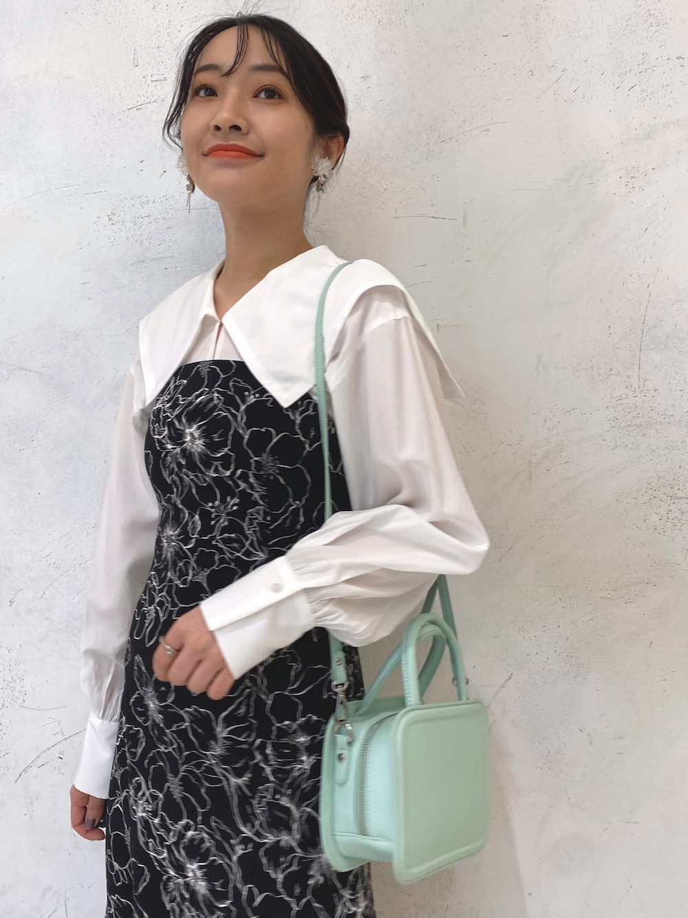 ベージュ系のブーツ、グリーン系のハンドバッグ、その他のワンピースを着用したレディースの冬コーディネートの5枚目の写真