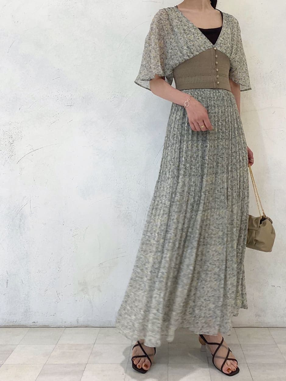 グリーン系のシャツ/ブラウス、ベージュ系のクラッチバッグ、グリーン系のスカートを着用したレディースの夏コーディネートの2枚目の写真