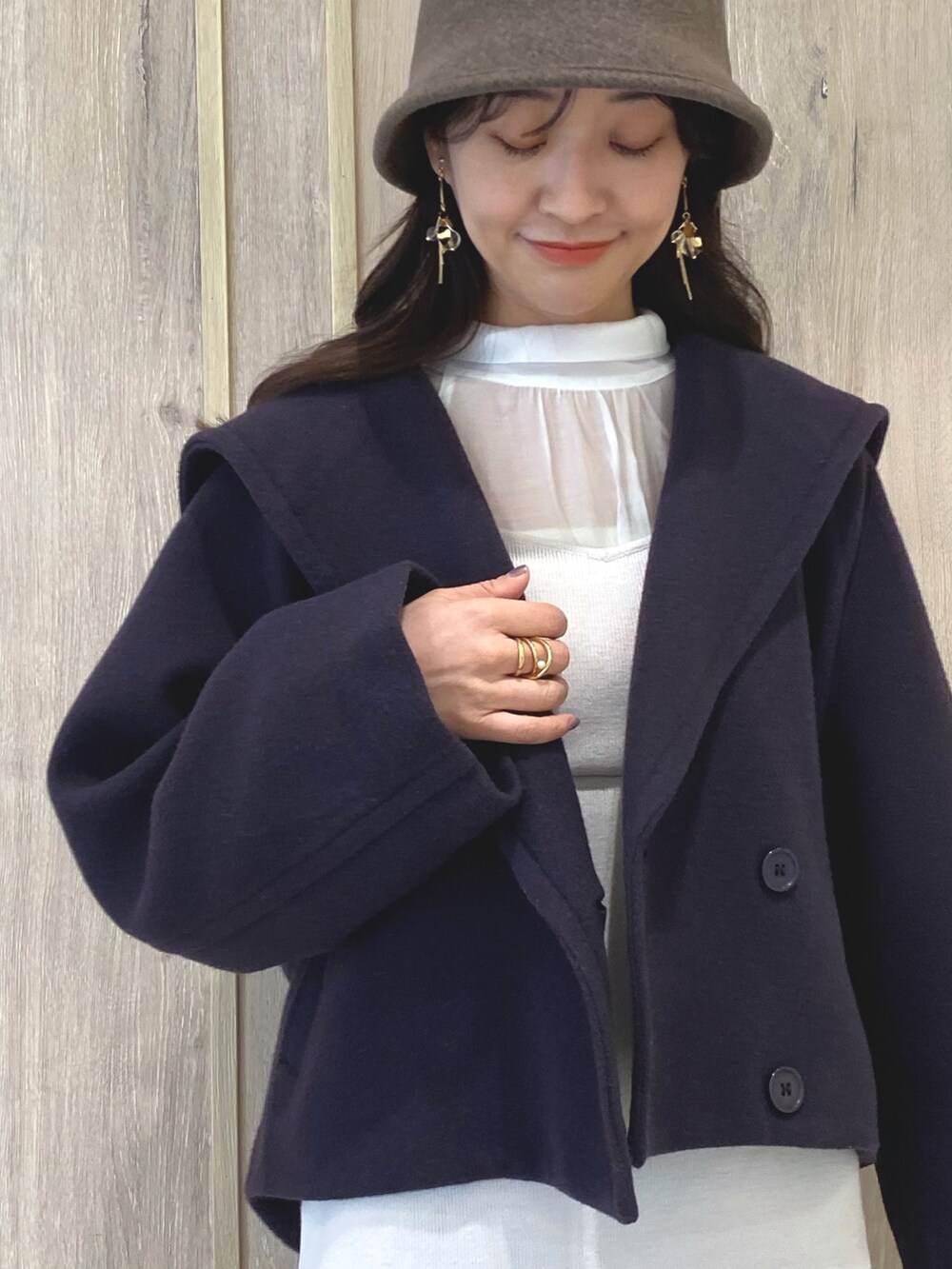 ベージュ系のブーツ、パープル系のその他アウター、ホワイト系のキャミソールを着用したレディースの冬コーディネートの6枚目の写真