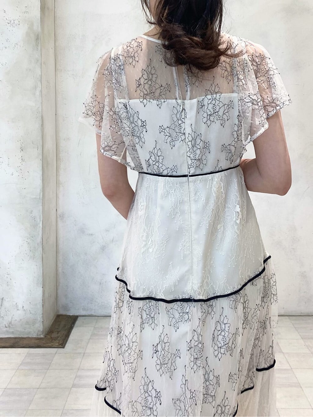 ベージュ系のTシャツ/カットソー、ホワイト系のワンピース、ブラウン系のサンダルを着用したレディースの夏コーディネートの6枚目の写真