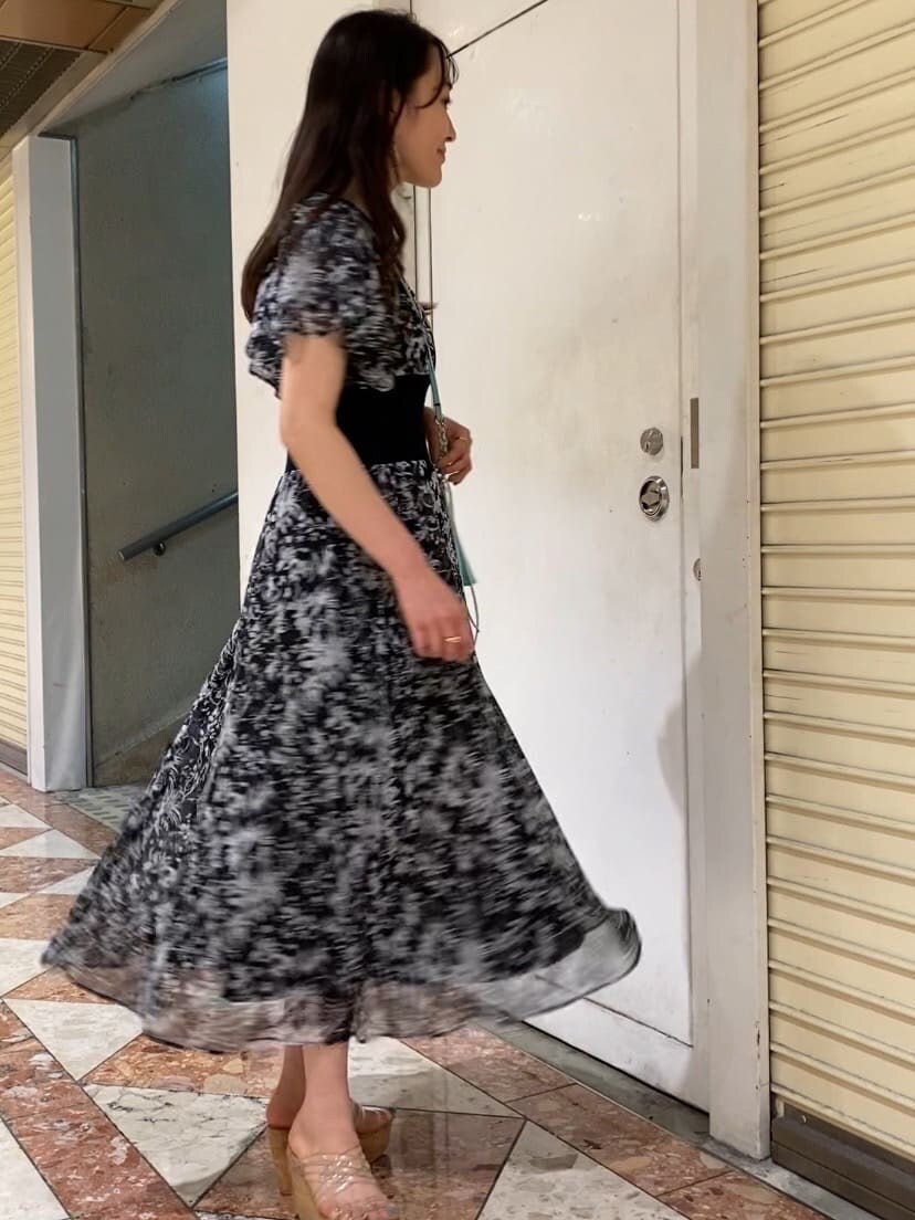 グリーン系のショルダーバッグ、その他のサンダル、ブラック系のワンピースを着用したレディースの夏コーディネートの3枚目の写真