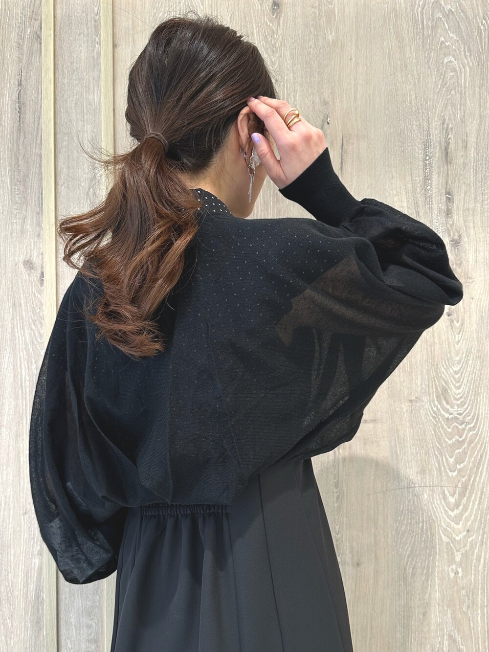 ブラック系のワンピース、ブルー系のハンドバッグ、シルバー系のサンダルを着用したレディースの春コーディネートの10枚目の写真