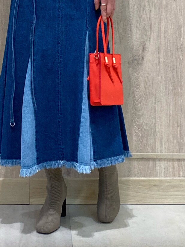 ホワイト系のTシャツ/カットソー、レッド系のハンドバッグ、ブルー系のスカートを着用したレディースの冬コーディネートの5枚目の写真