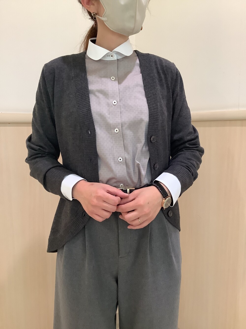 ブラウン系のビジネスシャツ、グレー系のカーディガン/ボレロ、ブラック系のベルトを着用したレディースの秋コーディネートの2枚目の写真