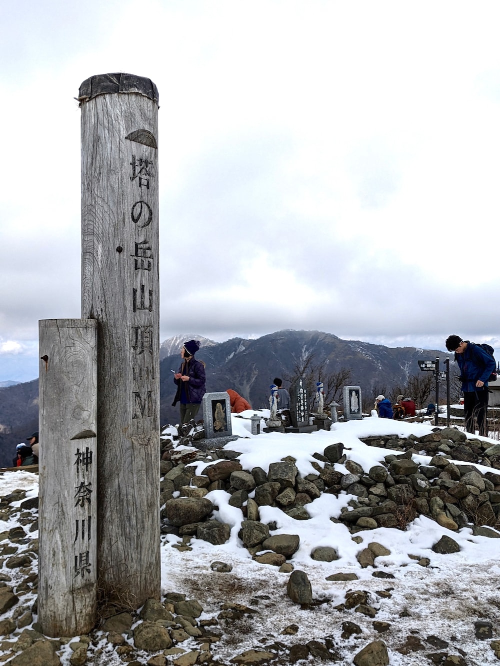 グリーン系のマウンテンパーカー、ブラック系のパンツ、ブラウン系のブーツを着用したメンズの春コーディネートの5枚目の写真