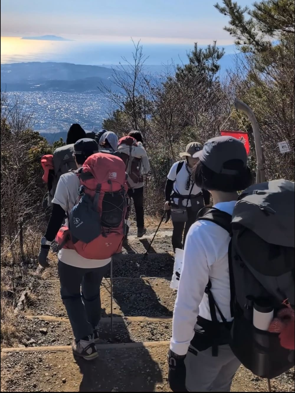 ベージュ系のパーカー、ブラウン系のパンツ、ブラウン系のバックパック/リュックを着用したメンズの冬コーディネートの3枚目の写真