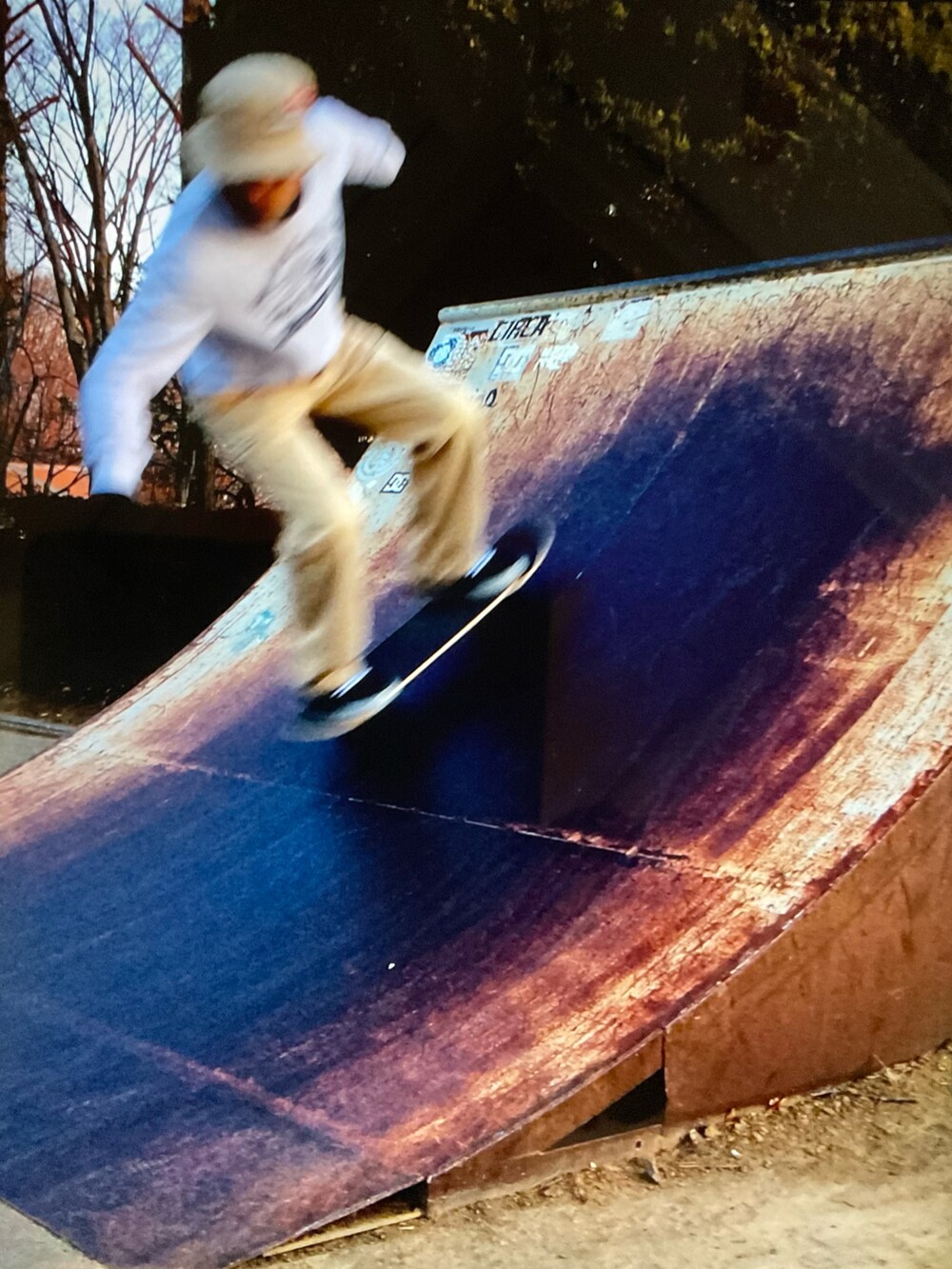 ホワイト系のスウェット、ベージュ系のチノパンツ、ブラック系のスニーカーを着用したメンズの夏コーディネートの3枚目の写真