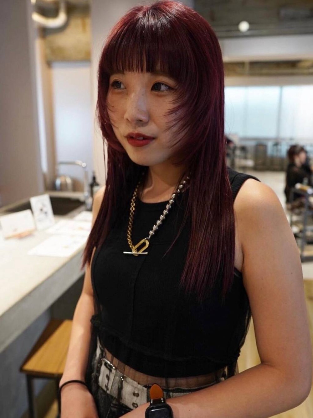 ブラック系のデニムパンツ、ブラック系のタンクトップ、ブラック系のワンピースを着用したレディースの冬コーディネートの2枚目の写真