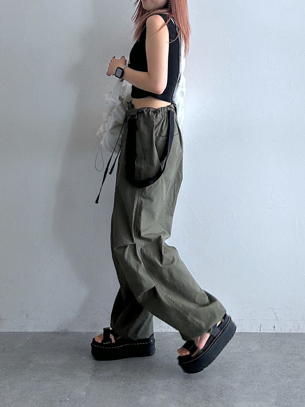 グリーン系のその他パンツ、ブラック系のタンクトップ、ホワイト系のショルダーバッグを着用したレディースの秋コーディネートの4枚目の写真