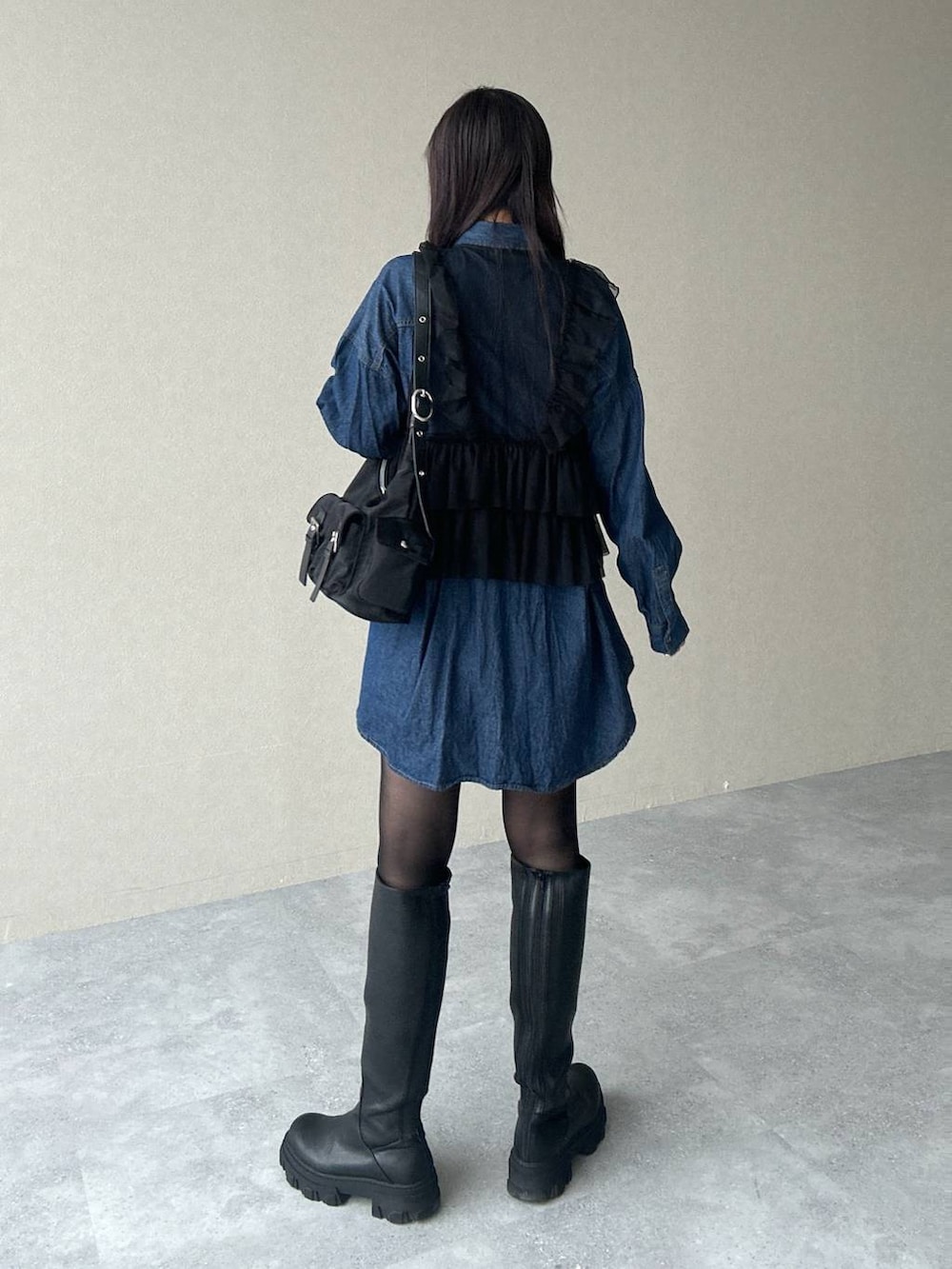 ブラック系のショルダーバッグ、ブルー系のシャツ/ブラウス、ブラック系のブーツを着用したレディースの春コーディネートの4枚目の写真