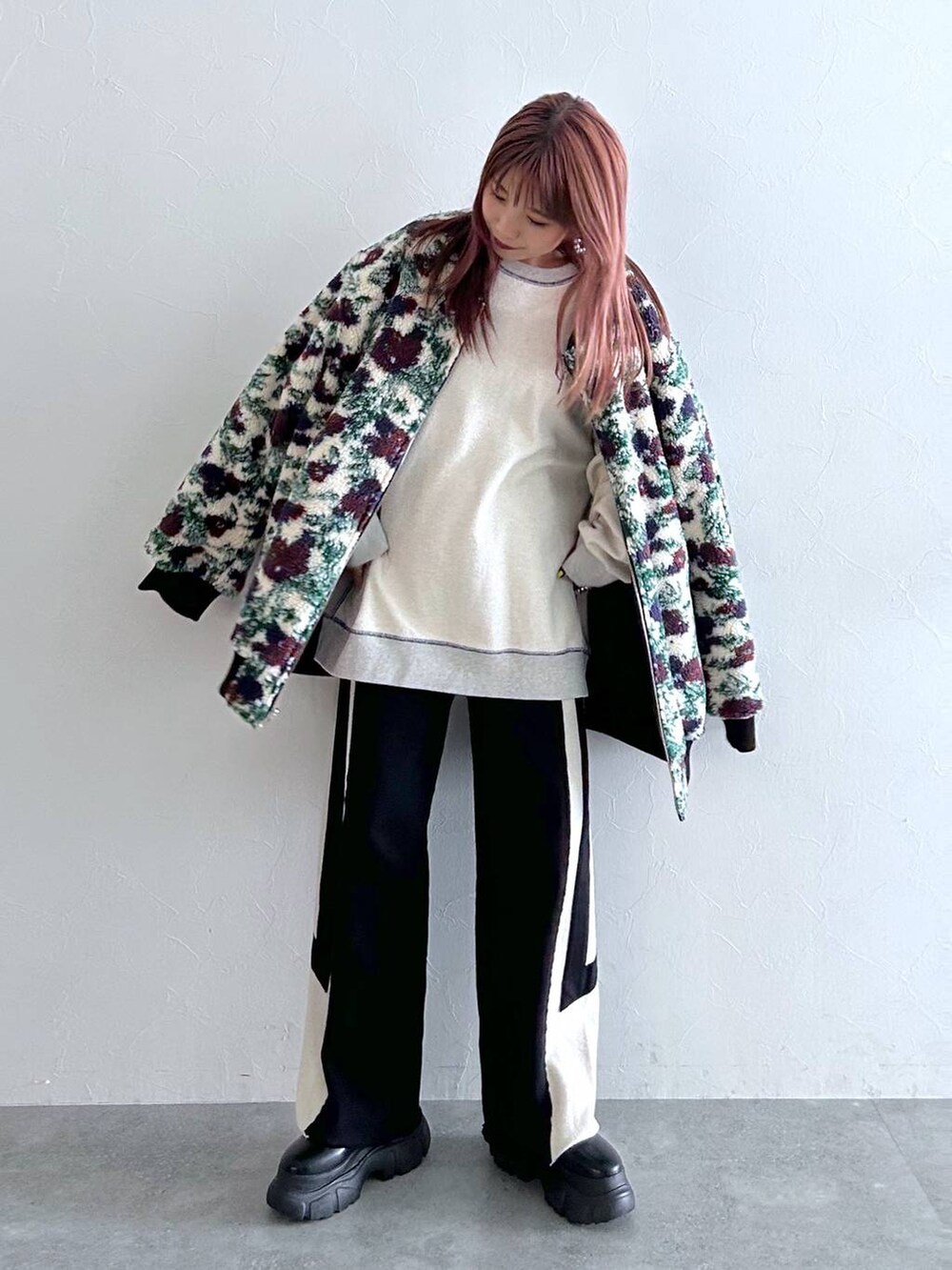 ブラック系のブルゾン、ブラック系のスウェットパンツ、ブラック系のブーツを着用したレディースの秋コーディネートの2枚目の写真