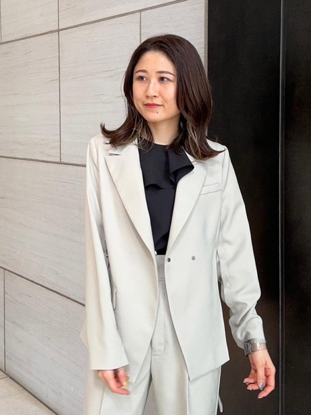 ベージュ系のセットアップ、ベージュ系のスラックスを着用したレディースの春コーディネートの6枚目の写真